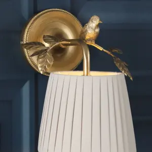 Egelton, skulpturell vegglampe med fugl på gren i gull